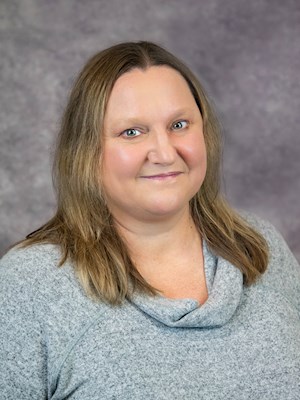 Dr. Tamara Daniels, MD, smiling portrait in a gray sweater, professional headshot for Spooner Health provider profile.