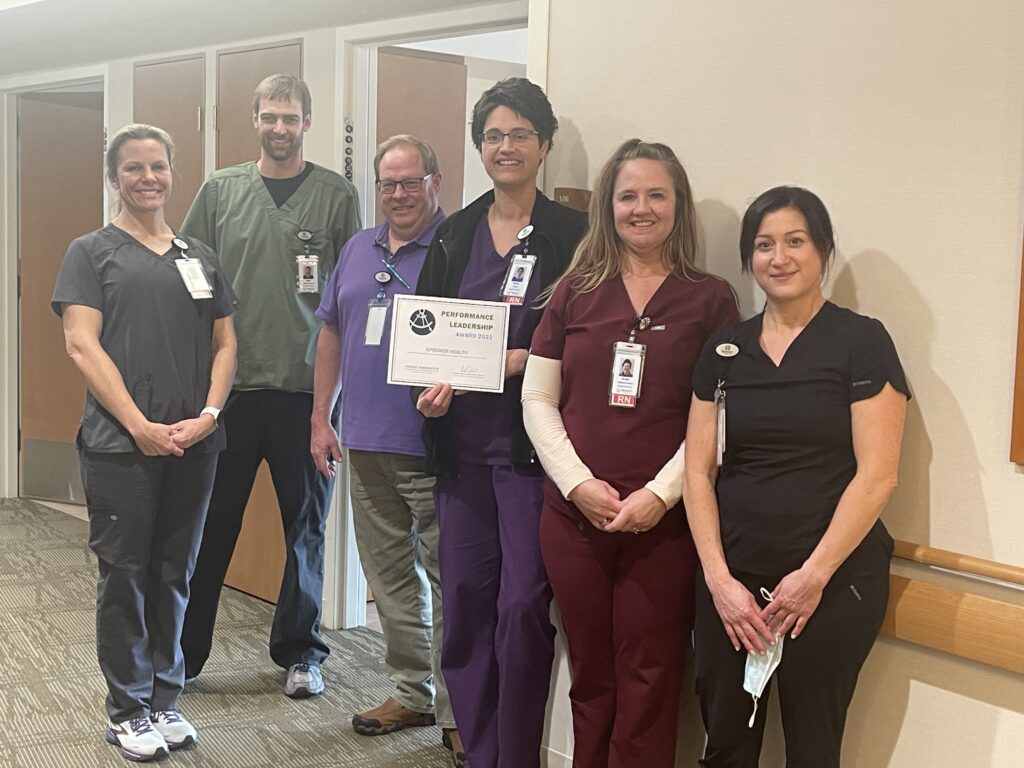 Inpatient team members at Spooner Health holding the Patient Perspective Award for 2023 from Chartis Center for Rural Health
