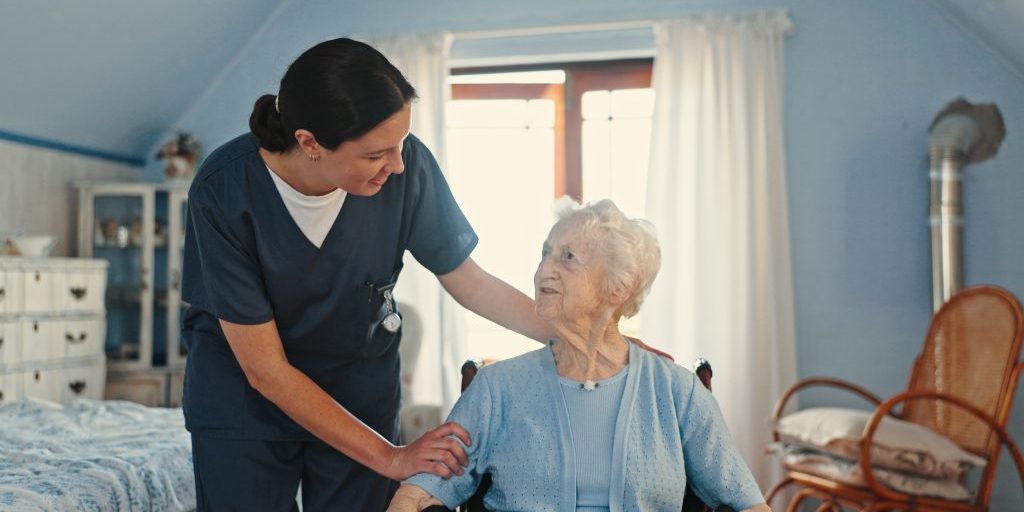 Wheelchair, nurse and support with old woman in bedroom for healthcare, caregiver and retirement. Volunteer, medical and elderly care with senior patient in nursing home for rehabilitation and trust.